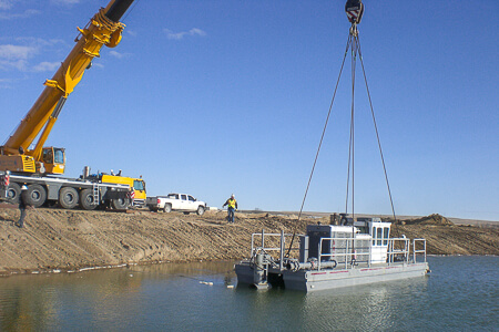 Rotomite 6000CD being put in lake by crane